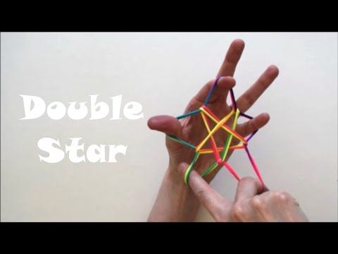 two hands are holding small colored sticks in front of the words double star above them