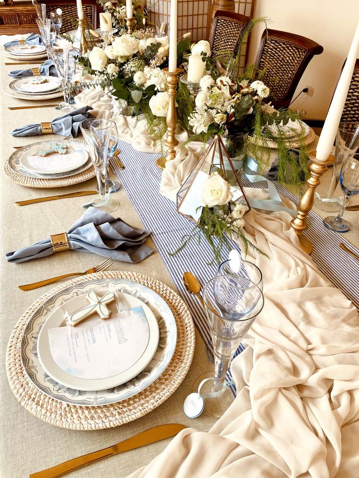 a table set with place settings and flowers