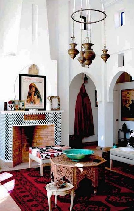 a living room filled with furniture and a fire place next to a wall mounted painting