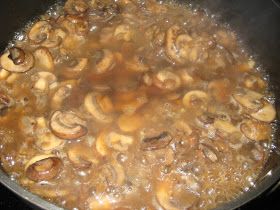 mushrooms are being cooked in a skillet on the stove top, ready to be eaten