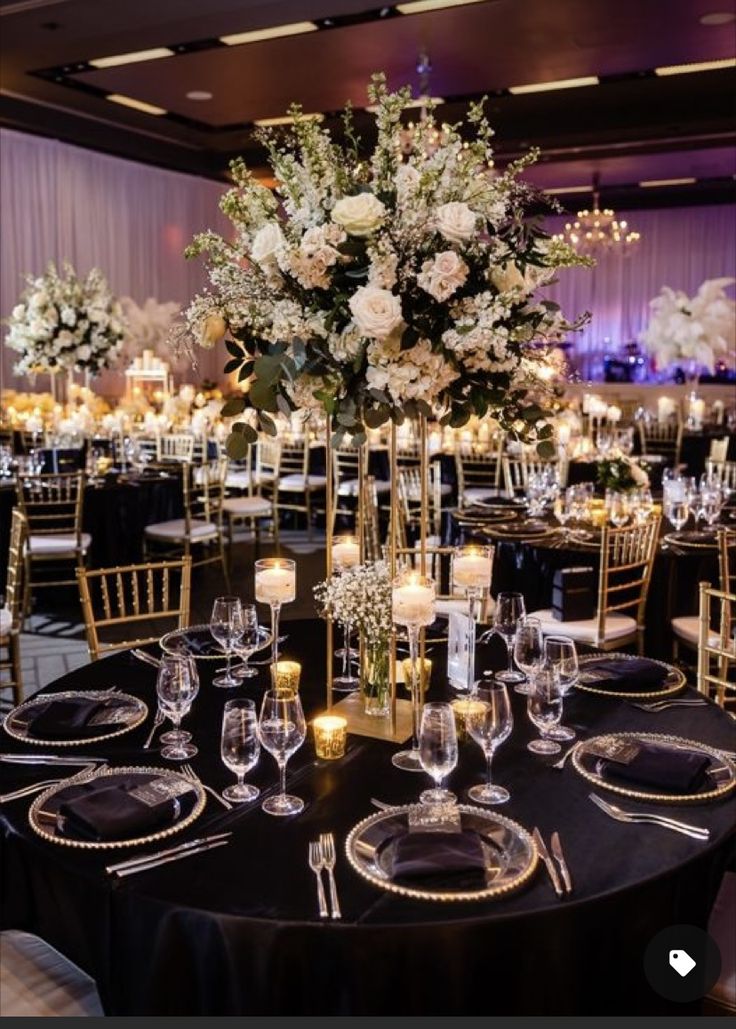 the centerpieces are set up with candles, flowers and place settings for an elegant reception