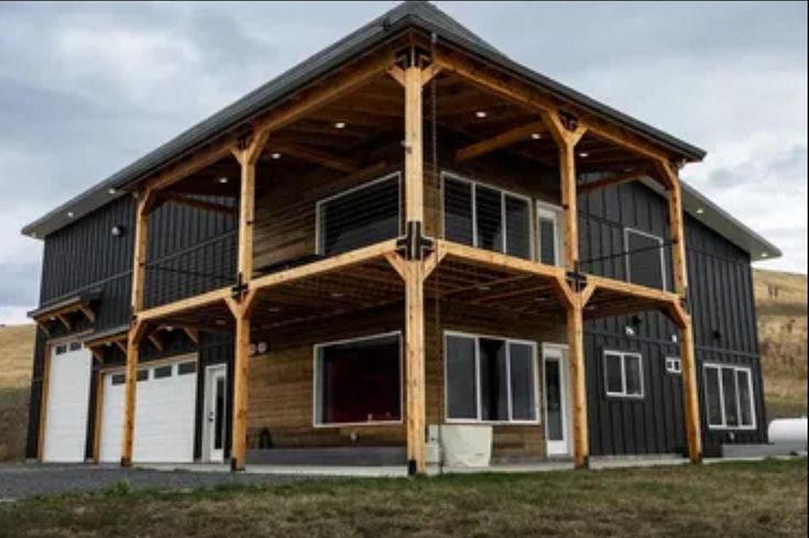 a two story house with lots of windows and balconies