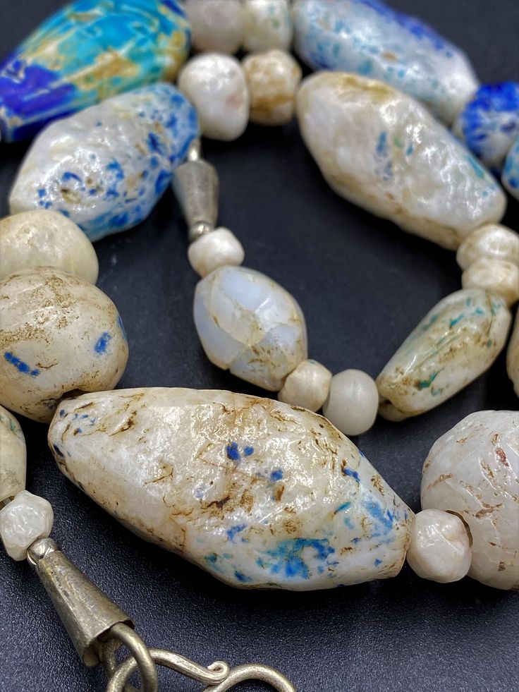 The Rare and Unique Beads necklace of Ancient Rough Rock Crystals Almost every Bead is Beautifully Carved and Beautifully painted with Blue color Rare and unique Item for collection Fast and Free shipping service White Artisan Beaded Necklaces With Oval Beads, Artisan White Gemstone Beads Necklaces, Artisan Necklaces With Large Beads For Healing, Artisan White Necklaces With Gemstone Beads, Artisan Single Strand Necklace For Healing, Artisan Single Strand Beads For Jewelry Making, Artisan Czech Glass Beaded Necklace With Large Beads, Artisan Single Strand Beaded Necklace With Oval Beads, Artisan Necklace With Czech Glass Round Beads