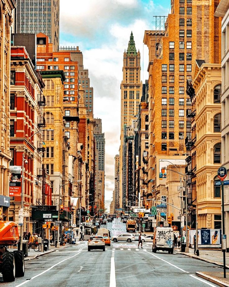 an empty city street lined with tall buildings