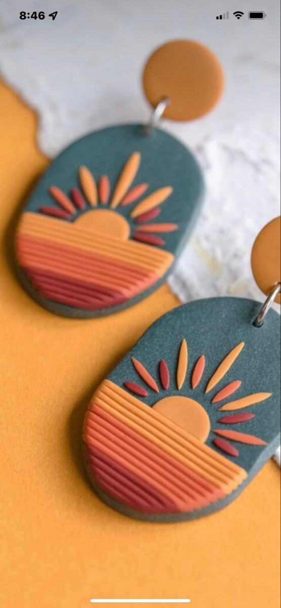 the earrings are made from wood and painted with oranges, yellows and browns