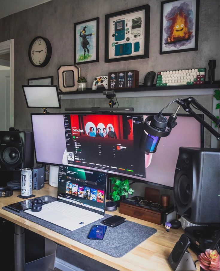 a computer desk with two monitors and speakers