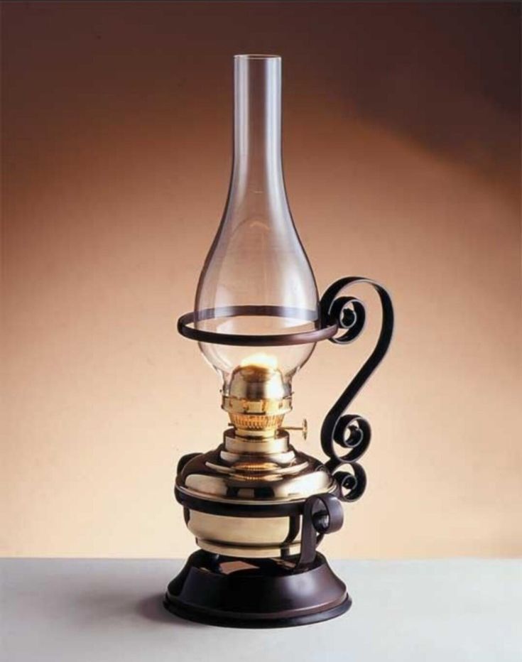 an old fashioned oil lamp on a table