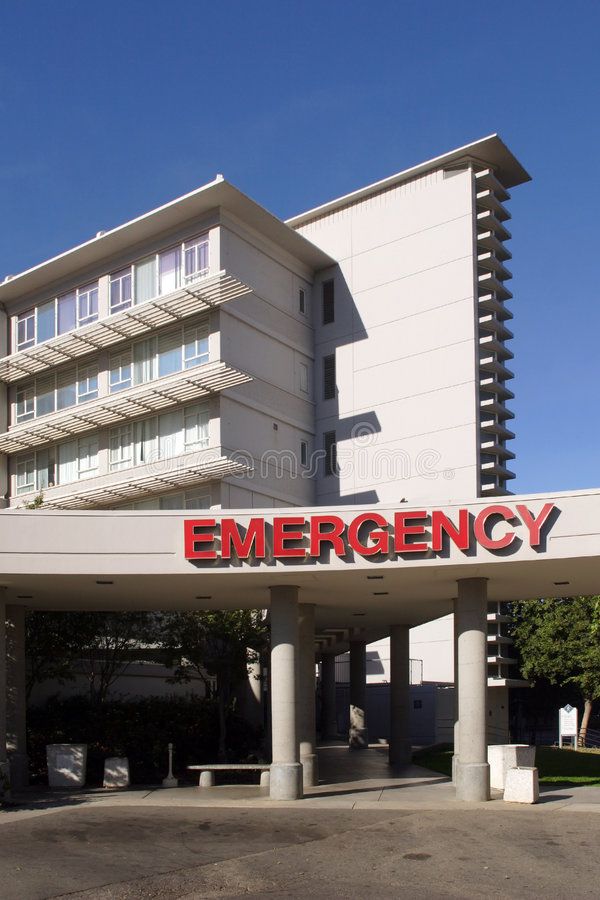 an emergency building with the word emergency on it's front and side entrance in red