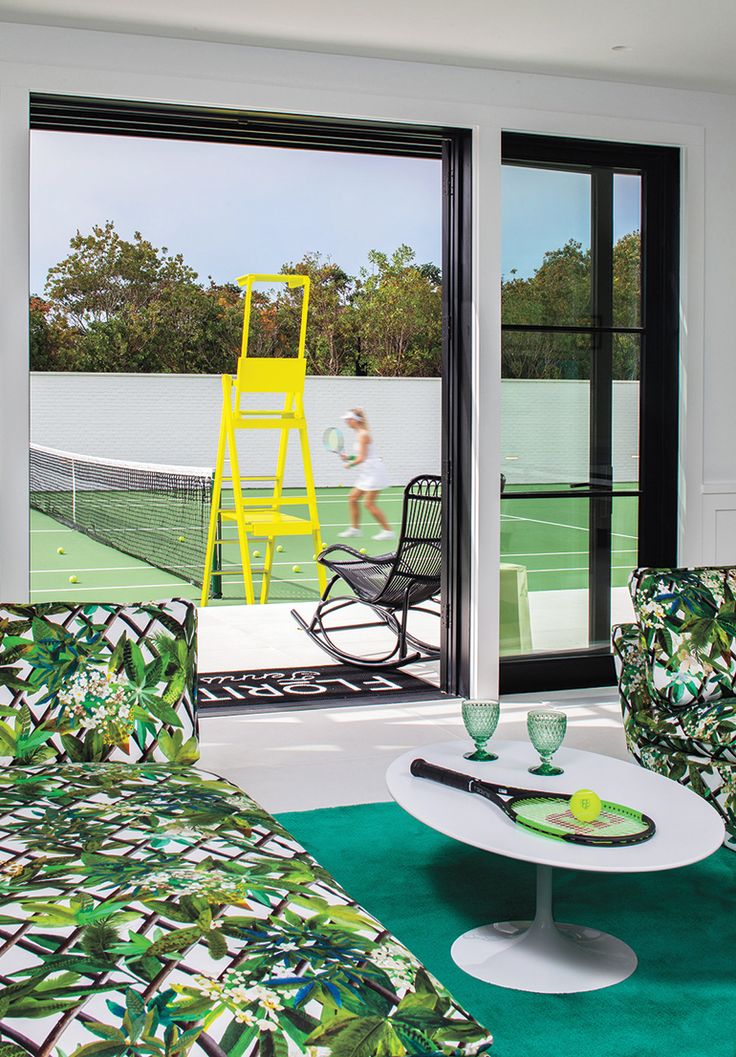 a living room filled with furniture and a tennis court