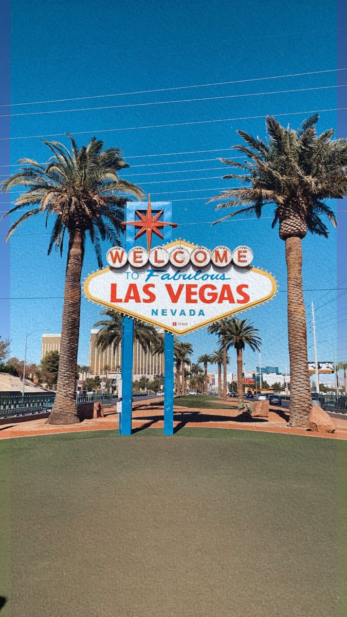 the welcome sign to las vegas is shown in front of palm trees and a casino