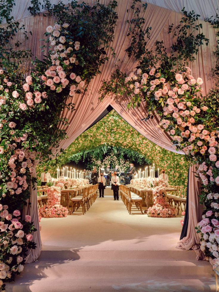 an archway decorated with flowers and greenery for a wedding reception at the ritzhed venue