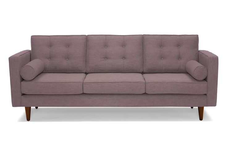 a gray couch sitting on top of a white floor