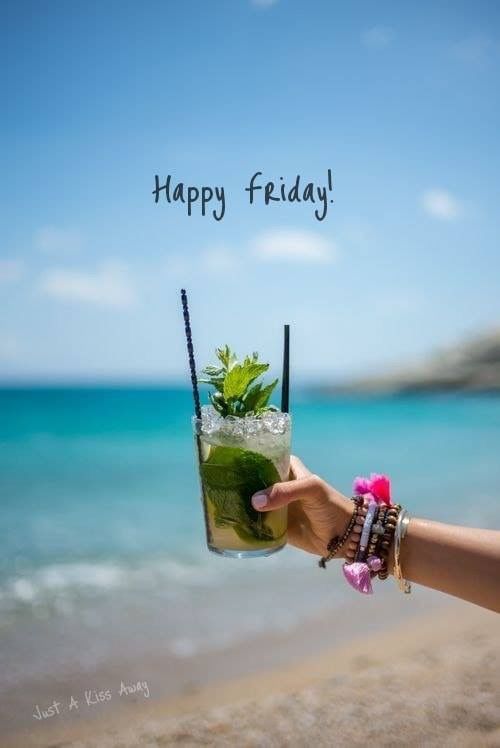 a person holding up a glass with a drink in it and the words happy friday written on it