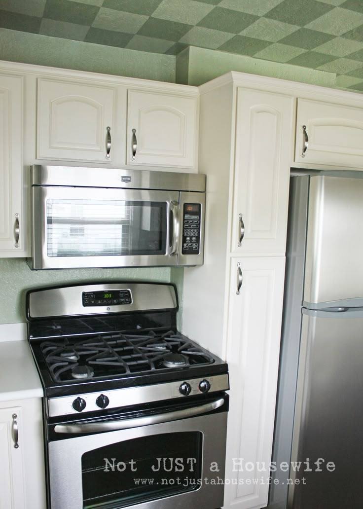 a stainless steel stove and refrigerator in a kitchen