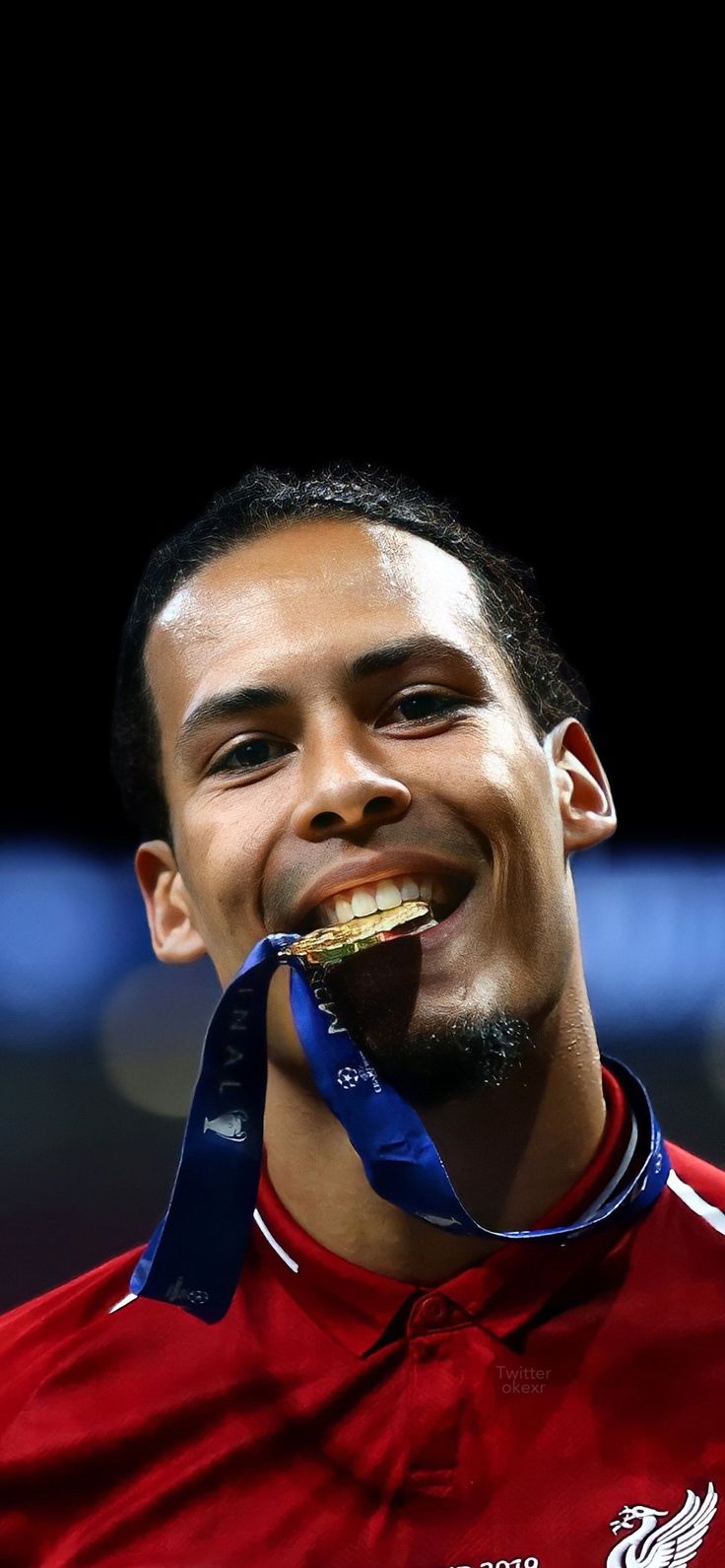 a man with a medal in his mouth