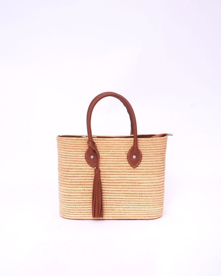 Do you want to look stylish and hippy? Get your hands on this handmade straw bag. It's high quality, eco-friendly, and handcrafted by women in Morocco. Its design is unique and timeless. Get yours now! we are proud to introduce our signature straw french bag to you. it is handmade by our talented artisan who has been working with us for years. this beautiful bag has a unique design that you would find nowhere else. the light and durable material are ideal for taking the bag on your adventures. S Travel Straw Shoulder Bag With Fringe, Travel Shoulder Straw Bag With Fringe, Vacation Top Handle Straw Bag With Braided Handles, Vacation Straw Bag With Braided Top Handle, Beige Tassel Bucket Bag For Vacation, Summer Brown Crochet Bag With Tassels, Brown Crochet Bag With Tassels For Summer, Casual Brown Straw Bag With Fringe, Brown Fringe Shoulder Bag For Vacation