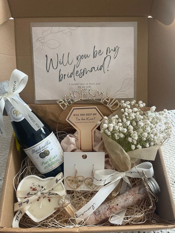 a box filled with lots of different types of wedding items and wine bottle in it