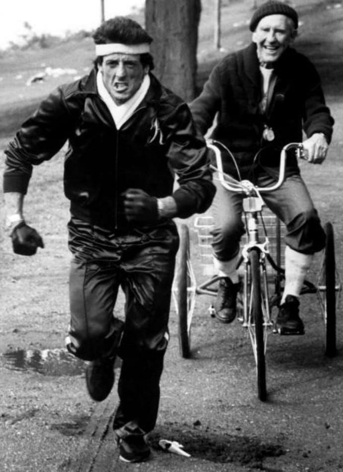 black and white photograph of two men riding bicycles