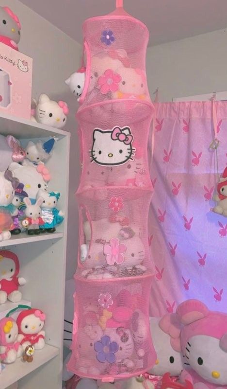 a pink hello kitty toy storage tower in a child's room