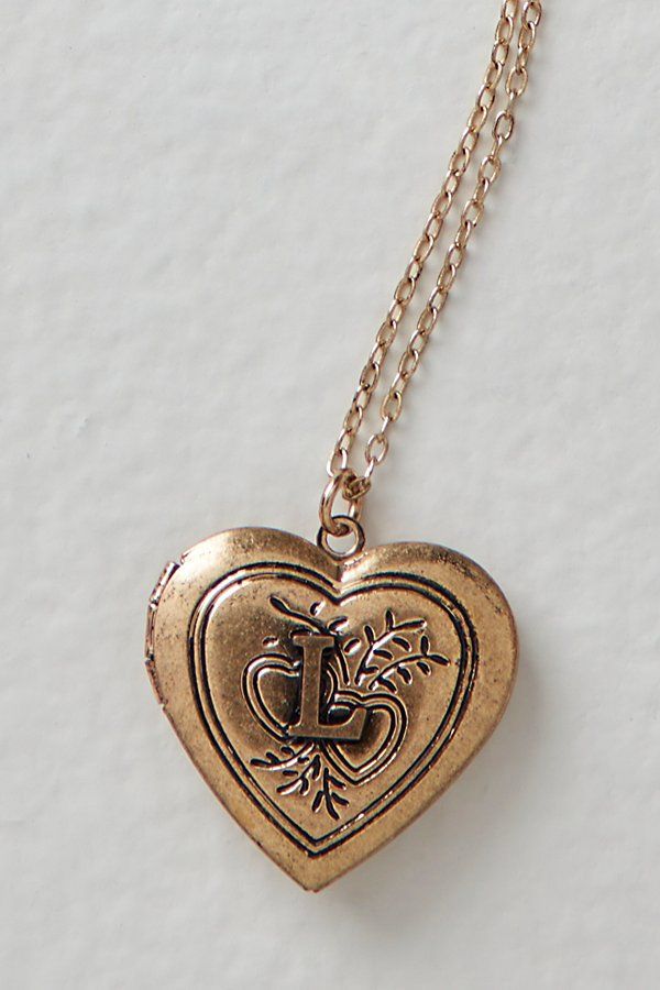 A super sweet gift or an accessory unique to you, this darling monogram necklace features a heart locket pendant with an initial engraving. **Features:** Dainty chain, heart locket pendant, hinge opening mechanism, monogram initial engraving, clasp closure **Why We | Monogram Necklace at Free People in L Pendant Name Necklace, Initial A Necklace, Jewelry With Initials, Initial Jewelry Silver, Gold Locket Aesthetic, Locket Outfit, Christmas Gifts Jewelry, Gifts To Get Your Bf For Christmas, I Necklace