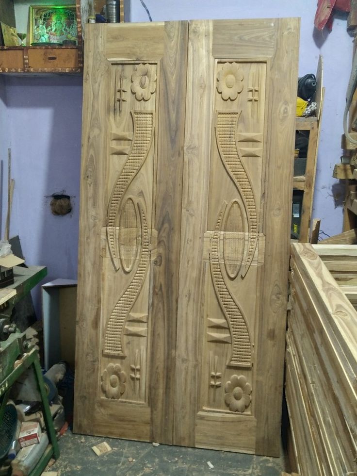 two wooden doors sitting next to each other on top of a table in a room