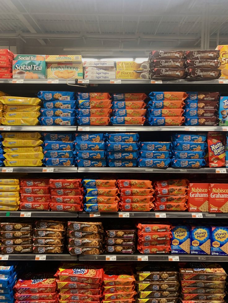 an aisle in a grocery store filled with lots of food and snacks on shelves next to each other