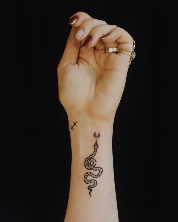 a woman's arm with a tattoo on it and a snake in the middle