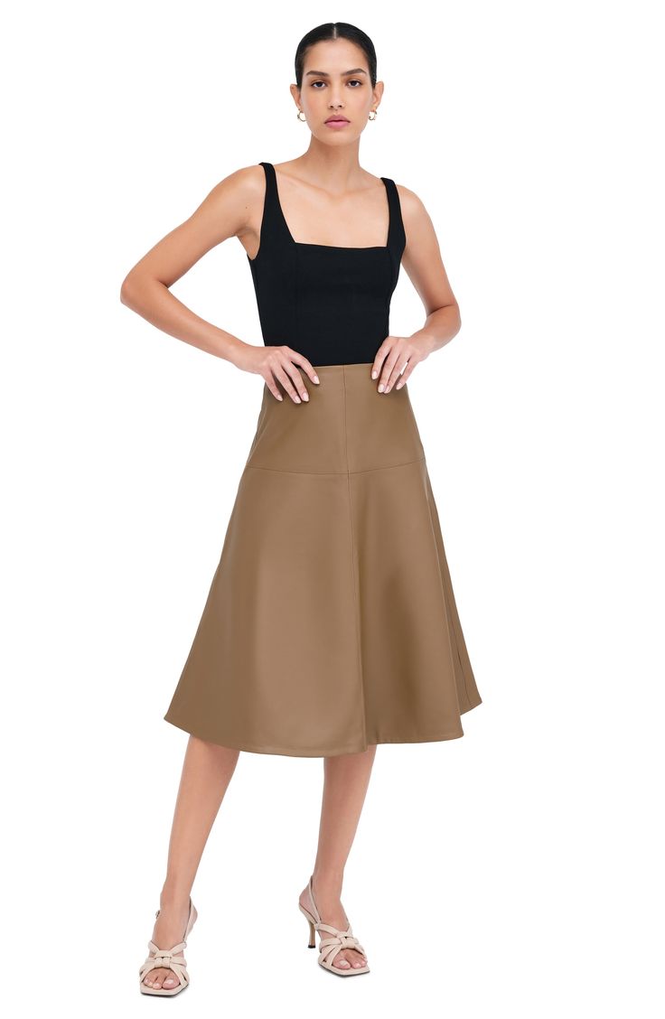 Glossy faux leather and architectural seaming add a modern mood to the classic A-line skirt. Hidden side-zip closure 93% polyester, 7% spandex Machine wash, line dry Imported Leather A Line Skirt, Vegan Leather Skirt, Leather Midi Skirt, Dressed Down, A Line Skirt, Italian Leather, A Line Skirts, Side Zip, Vegan Leather