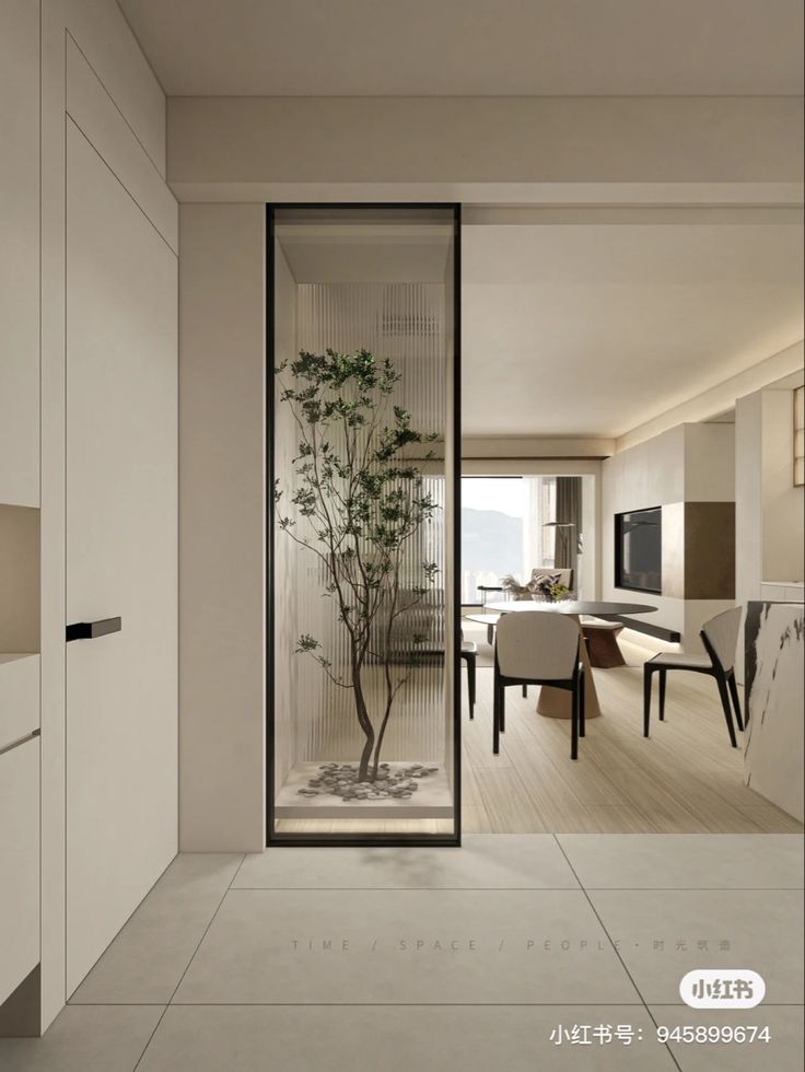 an open living room and dining area with glass doors leading to the outside patio, which has a bamboo tree in it