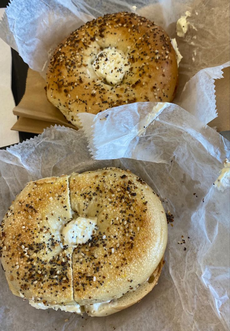 two bagels sitting on top of wax paper