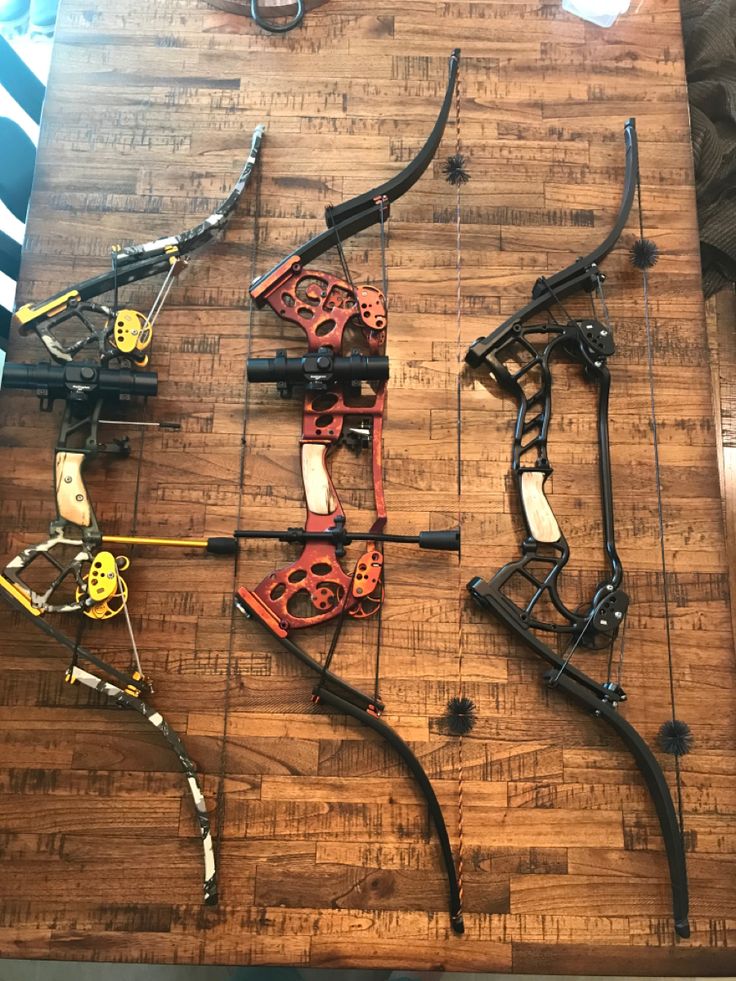 several different types of archery bows laid out on a table