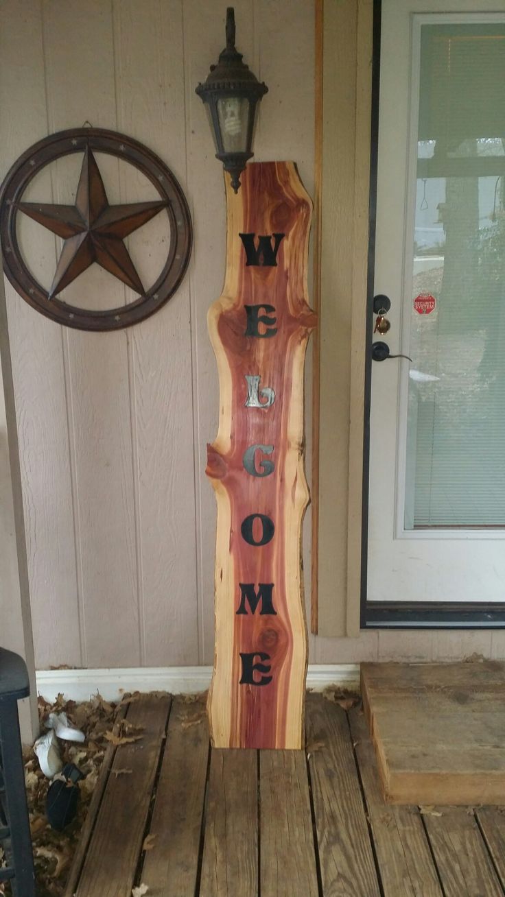 a wooden sign sitting on top of a wooden porch