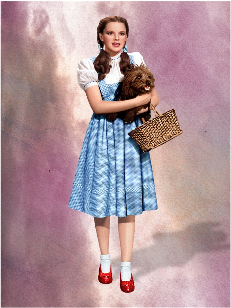 a woman in a blue dress holding a teddy bear wearing red shoes and a basket