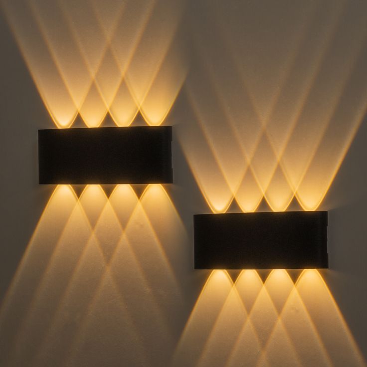 two rectangular lights are lit up on the wall