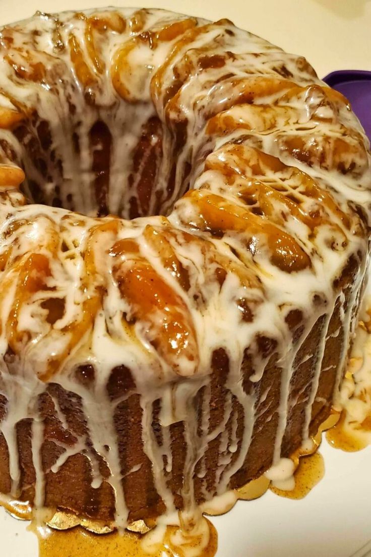 a bundt cake with icing and nuts on top