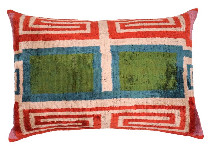 a red and blue pillow with squares on it's sides, against a white background