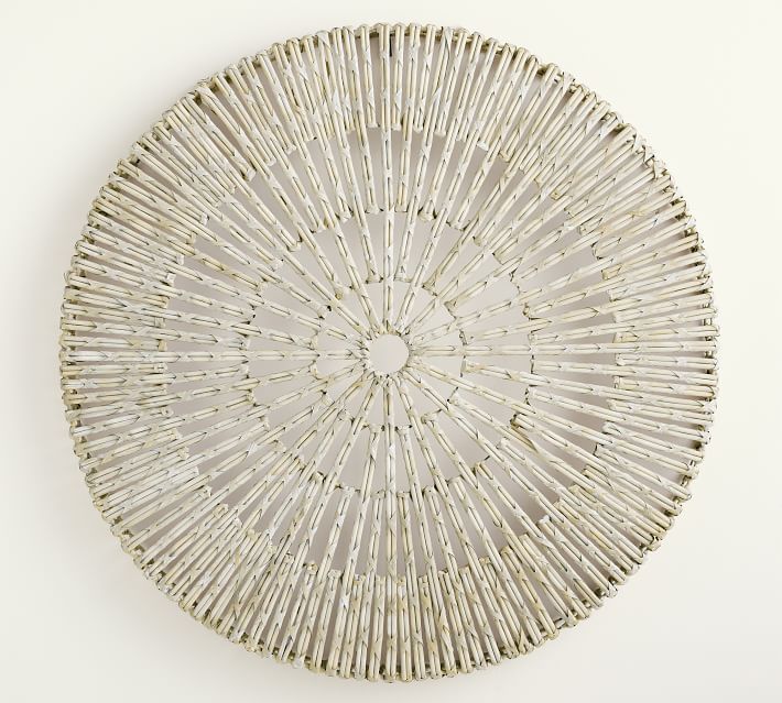 a white wall mounted wicker basket on the side of a wall in front of a white background