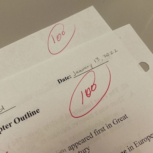 two papers with writing on them sitting next to each other