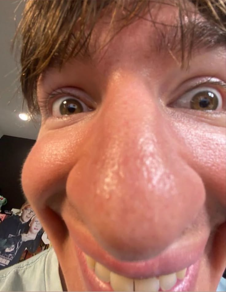 a close up of a person's face with a toothbrush in his mouth