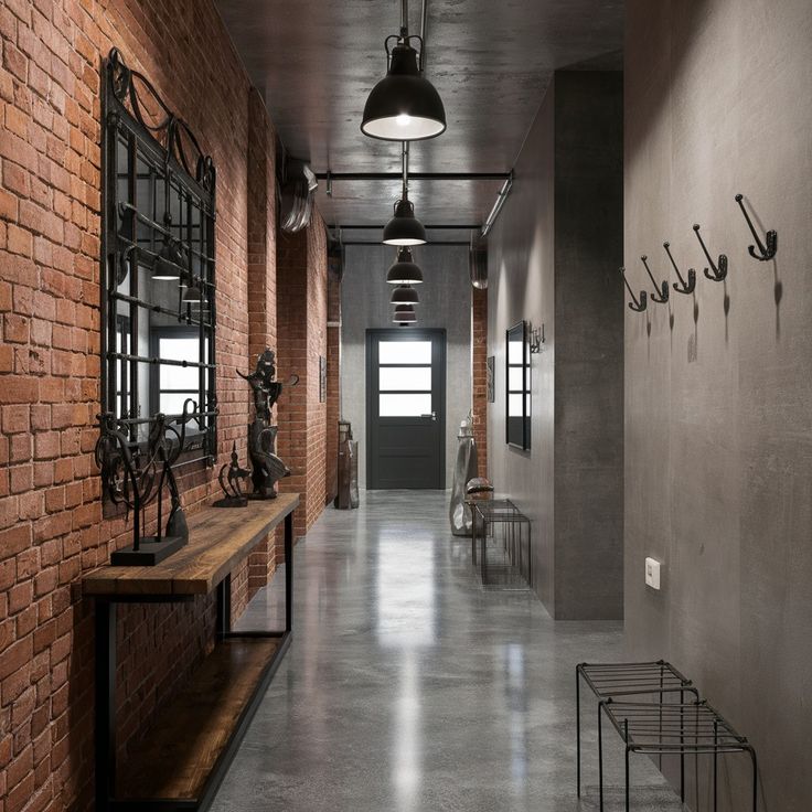 a long hallway with brick walls and metal fixtures on the wall, along with two benches