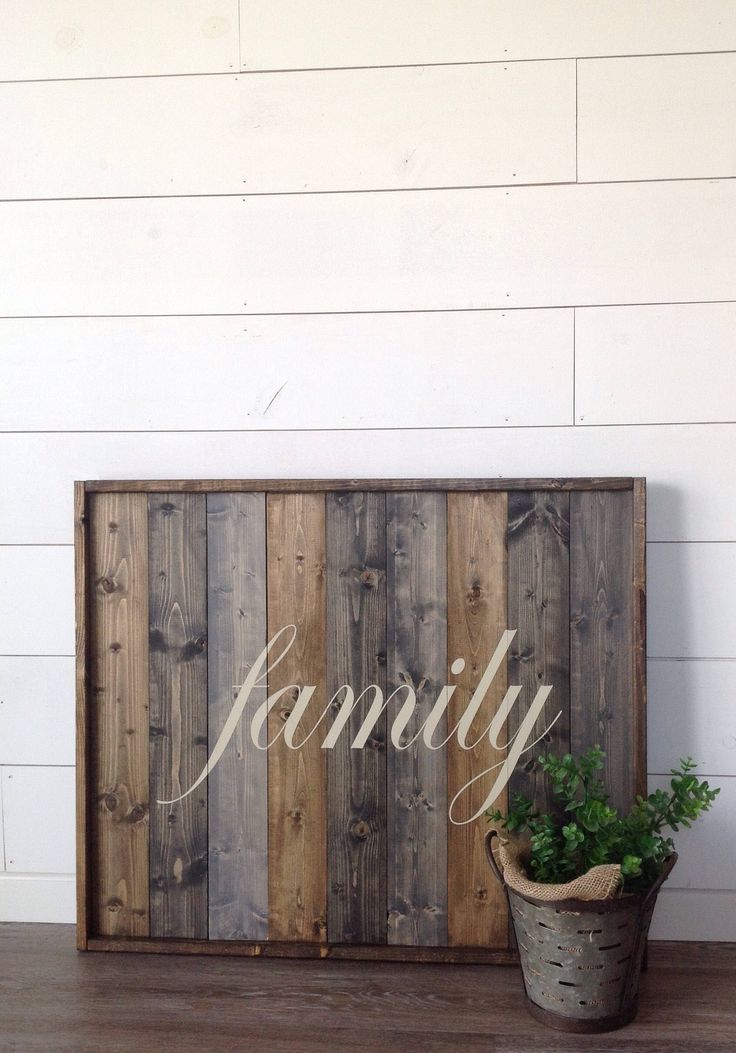 a potted plant sitting next to a wooden sign that says family on it's side