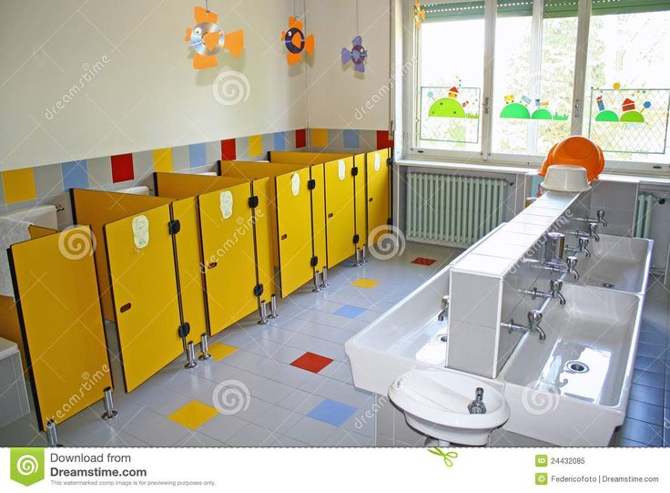 a bathroom with yellow and blue lockers in it