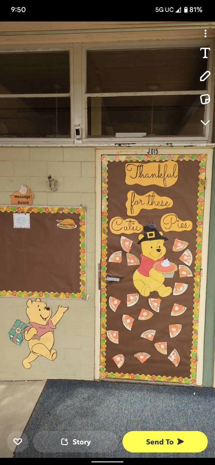 a bulletin board with winnie the pooh on it in front of a classroom door