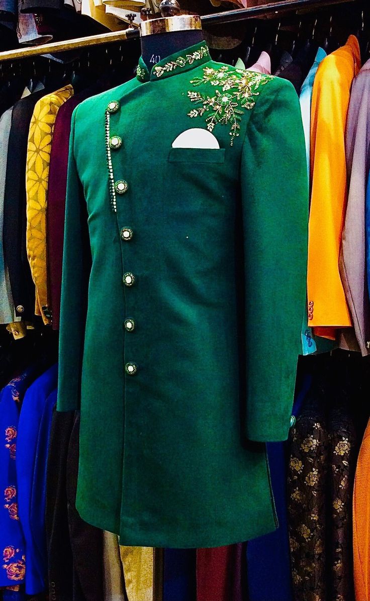 Item contains : Sherwani and Pants  Fabrics :   Swede/Velvet Colours :  Bottle green Style and Designs :  Sherwani or Jacket- Indo has mandarin collar and long sleeves with a full button placket asymmetric hem and multiple slits it's has embroidery over left shoulder pannel and over lapping angrakha design  Pants or Trousers- Pants boot cut style pants with 2 pockets and a fly on zip and hooks  Size :  Slim fit  Model height is 6 fit and wearing 40 size  Material and Care :  Polyester mix  Only Green Formal Traditional Wear With Naqshi Embroidery, Formal Green Traditional Wear With Naqshi Detailing, Formal Green Traditional Wear With Naqshi, Green Naqshi Traditional Wear For Formal Occasions, Fitted Green Bandhgala With Naqshi Detailing, Fitted Green Bandhgala With Naqshi, Green Bandhgala With Naqshi For Festivals, Festive Green Bandhgala With Naqshi Detailing, Festive Green Bandhgala With Naqshi