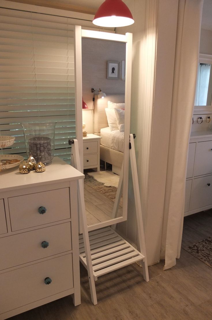 a white dresser and mirror in a room