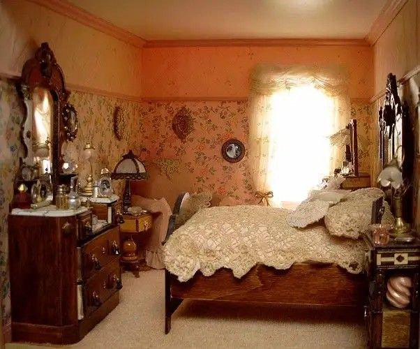 an old fashioned bedroom with floral wallpaper and antique furniture