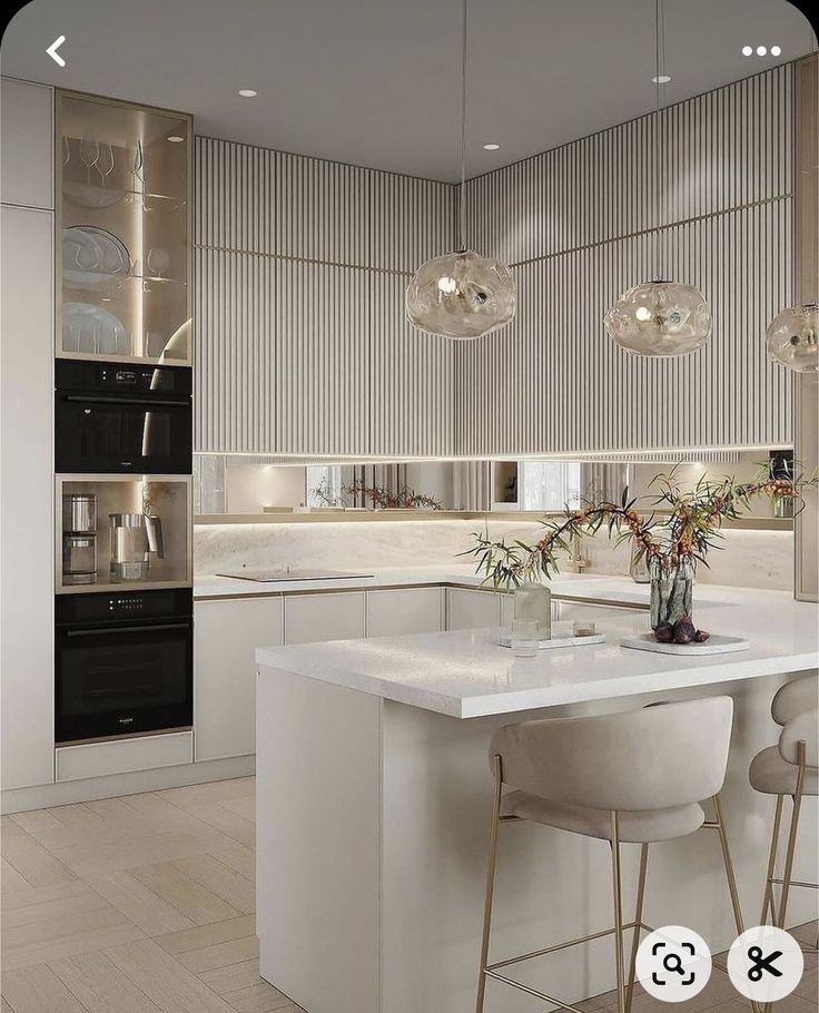 an image of a modern kitchen setting with bar stools and island in the middle