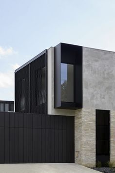 a black and white house is shown in the daytime time, with no people around it