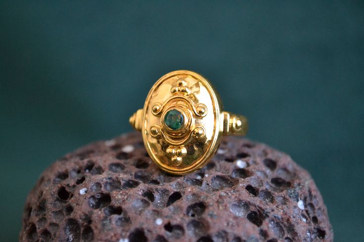 This byzantine inspired ring is entirely made with solid 18K Gold (750 Gold). In the center of the ring, there is a beautiful round shaped Emerald gemstone. It can also be purchased with Ruby or Sapphire Gemstone instead of Emerald. Gold Byzantine Signet Ring For Ceremonies, Gold Byzantine Signet Ring For Ceremonial Occasions, Gold Byzantine Style Ceremonial Signet Ring, Gold Ring With Emerald, Byzantine Ring, Etruscan Jewelry, Vintage Gold Ring, Byzantine Rings, Greek Ring