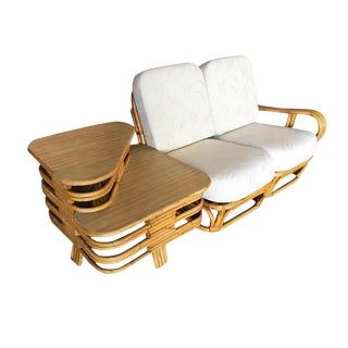 a set of three wooden chairs with white cushions on each chair and one sitting on the other